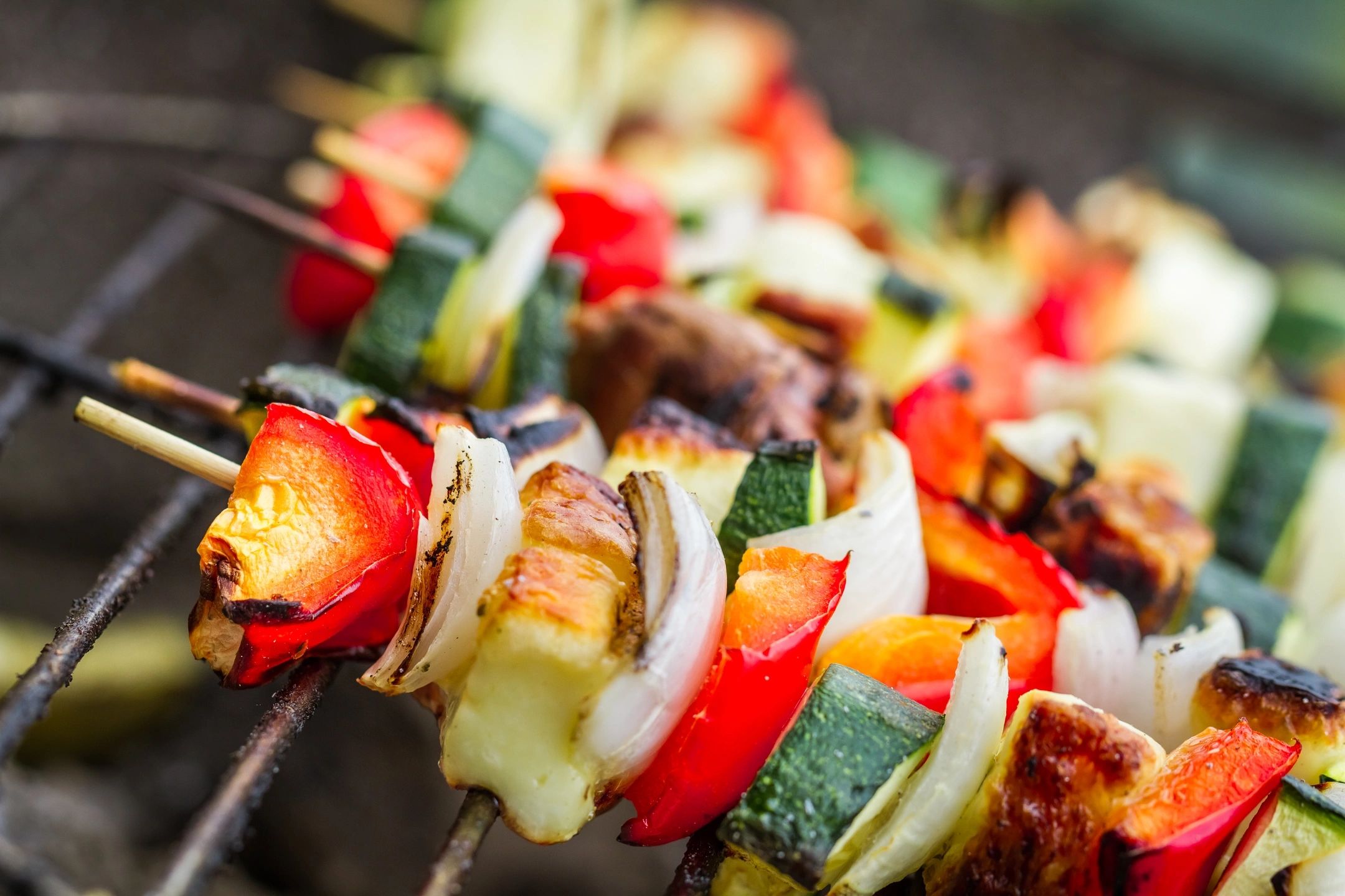 Photo of several vegetable kebabs on a grill